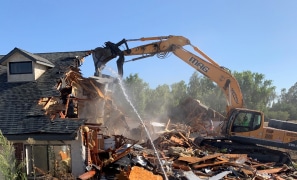 Demolition of a house using mag engineering techniques with an excavator.