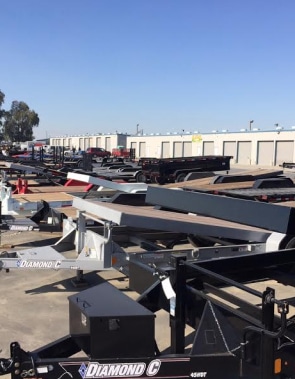 A plethora of trailers in a parking lot, showcasing MAG Engineering excellence.