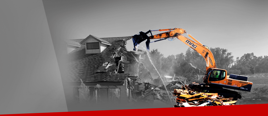 An image of an excavator demolishing a house.